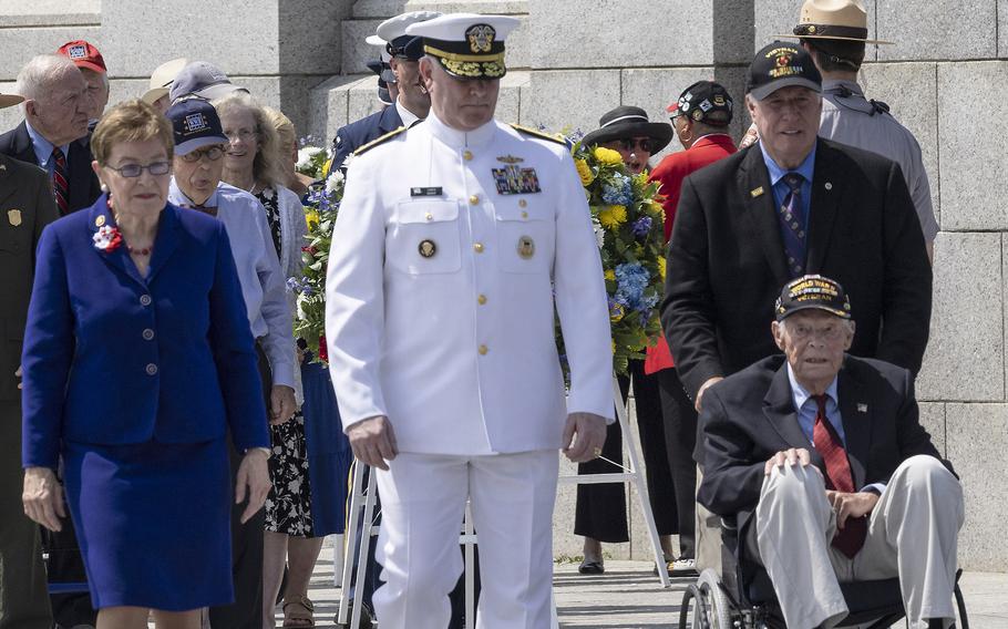 Rep. March Kaptur, D-Ohio, Adm. Christopher Grady and veteran Les Jones prepare to place a wreath at the 20th anniversary celebration of the National World War II Memorial in Washington, May 25, 2024.
