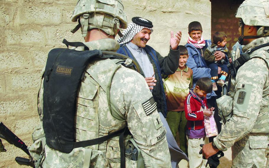 1st Lt. Dritan Xhakolli, left, 1st Platoon leader, Company A, Task Force 3-66 Armor, and Sgt. Moises Sotomayor, a soldier assigned to the 504th Battle Field Surveillance Brigade, talk with a resident Saturday in Tahweela, Iraq, Feb. 21, 2009. 