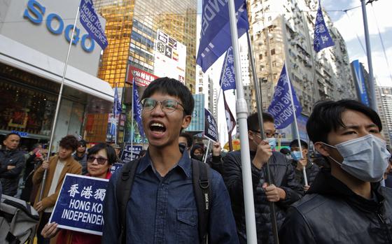 Demonstrators are seen marching in Hong Kong, with blue signs and flags reading “Hong Kong independence.”