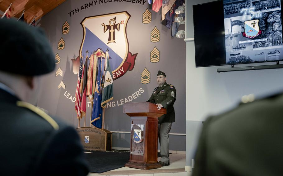 Command Sgt. Maj. Christopher Donaldson speaks at a podium for the 75th anniversary ceremony for the 7th Army NCO Academy.