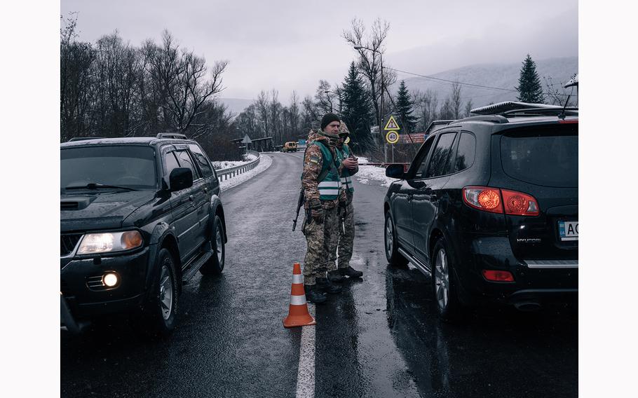 Members of the State Border Guard Service of Ukraine work at a checkpoint near the Romanian border in Veliatyno. 