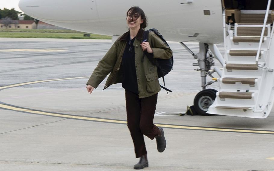 Cecilia Sala steps off the plane and onto the tarmac at Rome’s Ciampino airport.