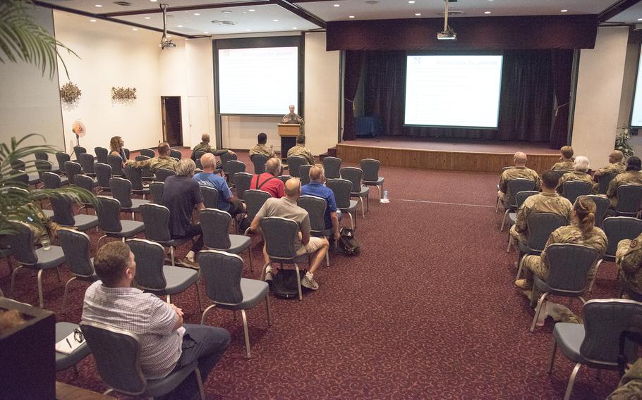 People gather at the Officers' Club for a town hall meeting on the Military Health System Genesis recordkeeping system at Yokota Air Base, Japan, Thursday, Aug. 31, 2023.