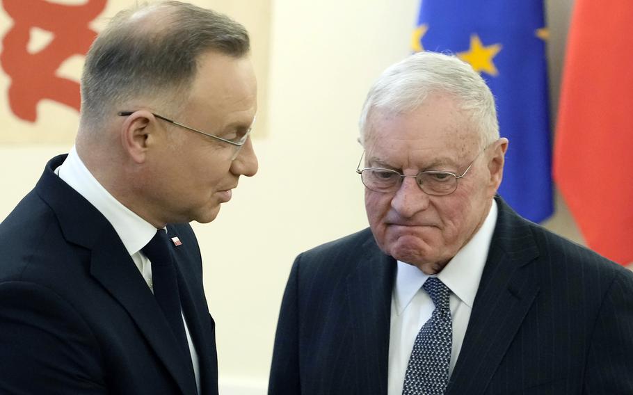 Poland’s President Andrzej Duda, left, greets U.S. envoy to Ukraine, Keith Kellog