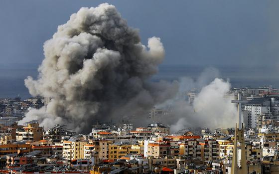 Smoke rises over a city skyline following an airstrike.