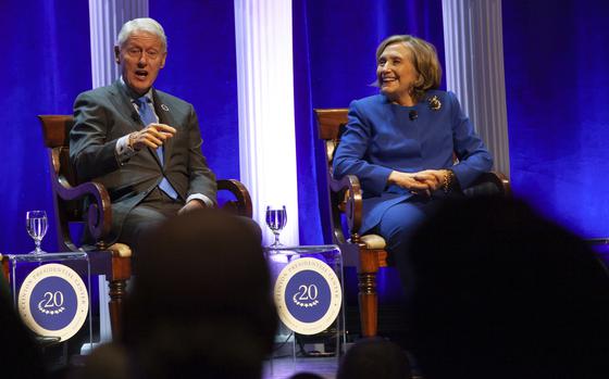 Former President Bill Clinton and former Secretary of State Hillary Rodham Clinton respond to audience questions on Saturday, Dec. 7, 2024 at the Robinson Center auditorum in Little Rock, Ark. (AP Photo/Katie Adkins)