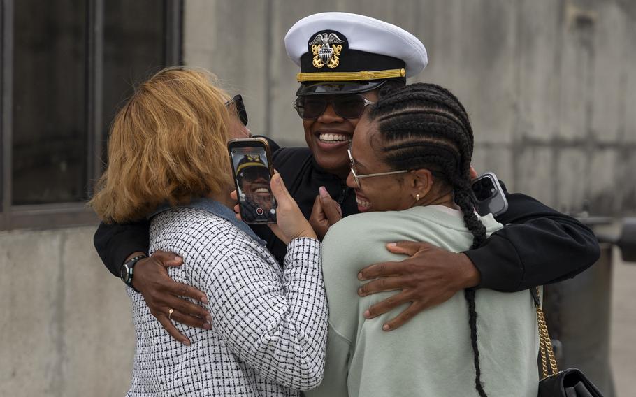 Lt. j.g. Alescia Austin greats her family after the USS Leyte Gulf returned to Naval Station Norfolk on May 17, 2024, following its final deployment.