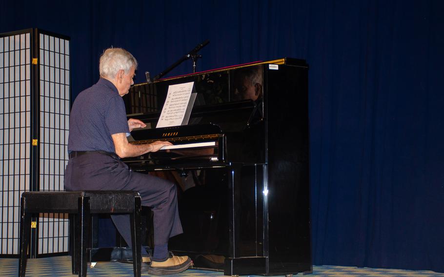 Holocaust survivor Janos Cegledy, a pianist and composer, performs for students in the Officers' Club at Yokosuka Naval Base, Japan, May 10, 2024.