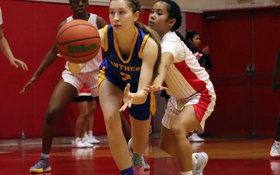 Yokota's Molly Bogdan reaches for the ball against Kinnick's Lindsey Andrade.