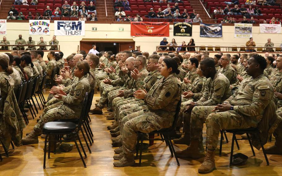 Troops applaud.