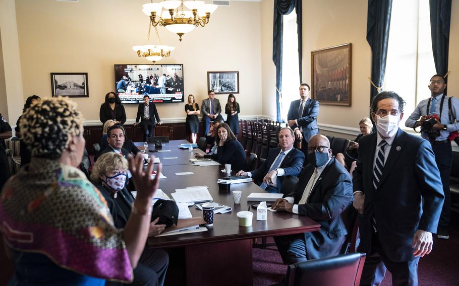 Members of the House select committee on the Jan. 6 attack huddle in a private meeting room moments before the start of their first hearing with Capitol Hill police witnesses on Capitol Hill on July 27, 2021 in Washington. 