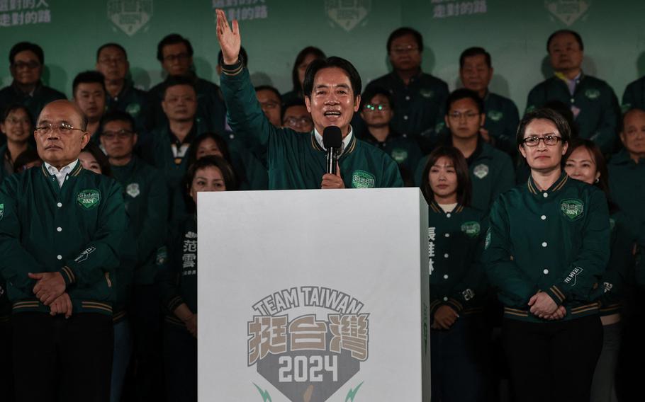 Taiwan's President-elect Lai Ching-te, middle, addresses supporters as he stands with his running mate Hsiao Bi-khim, right, during a rally outside the headquarters of the Democratic Progressive Party in Taipei on Saturday, Jan. 13, 2024, after Lai won the presidential election.