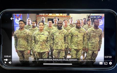 Soldiers from U.S. Army Garrison Rheinland-Pfalz stand at attention while the national anthem is played during the Lions-Bears football game broadcast on CBS and the American Forces Network, Nov. 28, 2024.