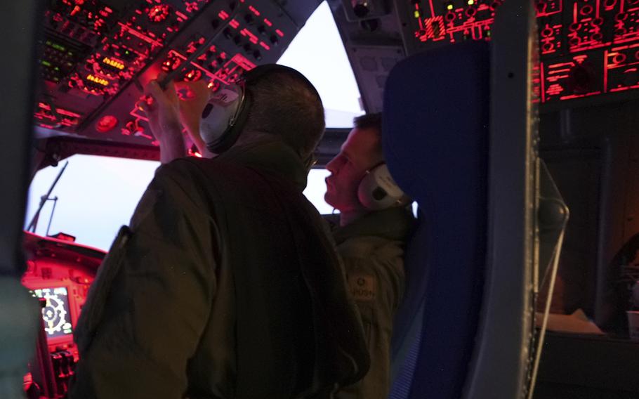 A flight-deck crew monitors their cockpit instruments.