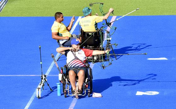 Army veteran Jason Tabansky aims during his first knockout match against Brazil's Eugenio Santana Franco in the men's individual W1 para archery competition at the 2024 Paralympic Games on Sunday, Sept. 1, 2024, at the Invalides in Paris.