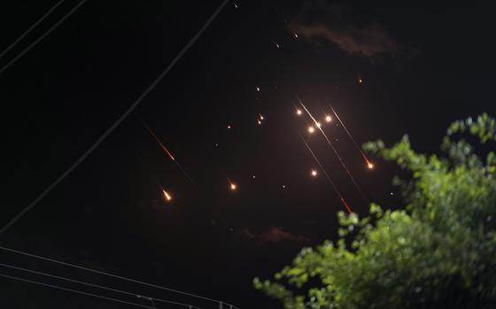 Missiles launched from Iran towards Israel streak across the night sky as seen from Deir al-Balah, Gaza Strip, Tuesday, Oct. 1, 2024. (AP Photo/Abdel Kareem Hana)