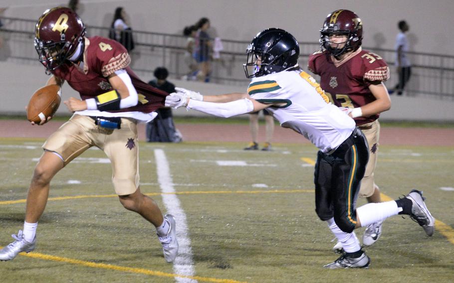 Edgren's Ethan Wong gets a couple of fists full of Perry quarterback Jordan Burford's jersey.