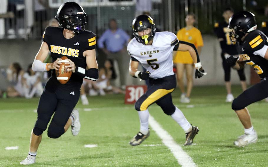 ASIJ quarterback Isreal Rodriguez gets pursued by Kadena's Ethan Ferch.