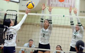 AOLG's Maria Cruz hits against Kubasaki's Runa Holladay and Cameron Eavers.