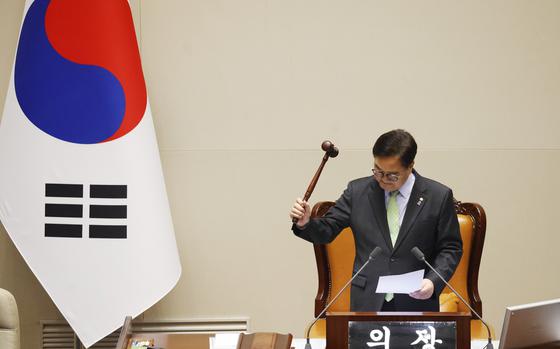 South Korean National Assembly Speaker Woo Won-shik announces bangs the gavel to announce that "the voting cannot take place" because the quorum was not reached during a plenary session for the impeachment vote of South Korean President Yoon Suk Yeol is set to take place at the National Assembly in Seoul, South Korea, Saturday, Dec. 7, 2024. (Jeon Heon-kyun/Pool Photo via AP)