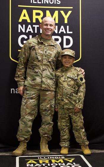 Jamir Gibbs of Marion, Ill., poses with 1st Sgt. Beau Detrick after Jamir’s “promotion” ceremony. 