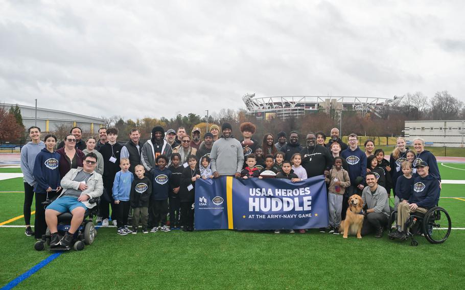 Army Maj. Gen. (Ret.) John Richardson, SVP of Military Affairs at USAA, and Robert Griffin III (RGIII) pose with local military kids