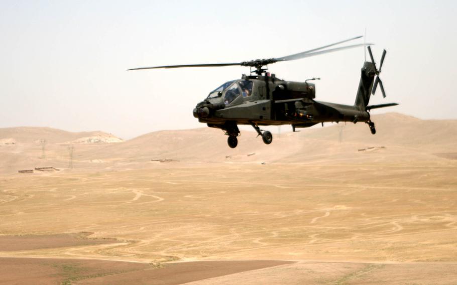 An Apache helicopter flies over the desert terrain between Tall'Afar and Mosul, Iraq, June 14, 2006. In a week that saw U.S.-made attack helicopters strafing a Palestinian city and Israeli settlers rampaging through a village filled with American citizens, the Biden administration finds itself caught up in a rapidly escalating conflict.