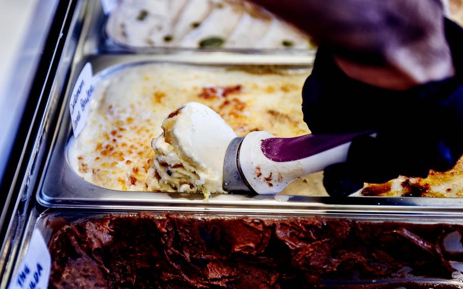 A worker scoops ice cream for a customer at a shop in Bahrain.