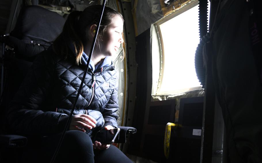 Yokota High School ninth-grader Mallory Cochran gazes out the window of a C-130J Super Hercules during a Fly Girls excursion over Tokyo, on March 8, 2024. 