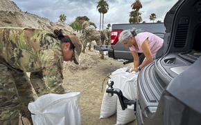 An Airman assigned to the 6th Air Refueling Wing fills sandbags with family members ahead of Hurricane Milton at MacDill Air Force Base, Florida, Oct. 7, 2024. Hurricane Milton is expected to make landfall in the Tampa Bay area later this week. (U.S. Air Force photo by Staff Sgt. Lauren Cobin)