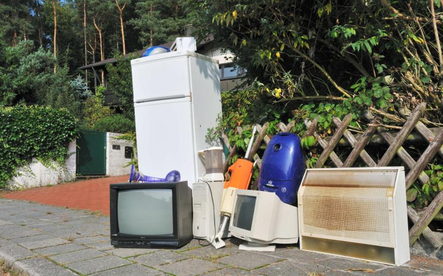 A television, a refrigerator and a computer monitor are among the items placed outside for pickup.