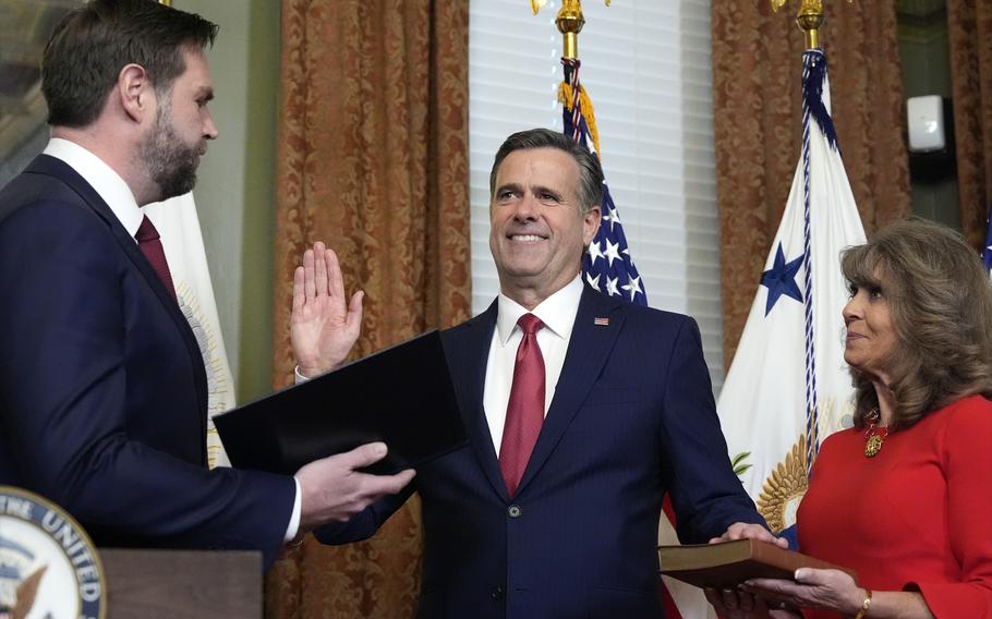 Vice President JD Vance swears in John Ratcliffe as CIA Director as his wife Michele holds the Bible in the Vice Presidential ceremonial office in the Eisenhower Executive Office Building on the White House campus.