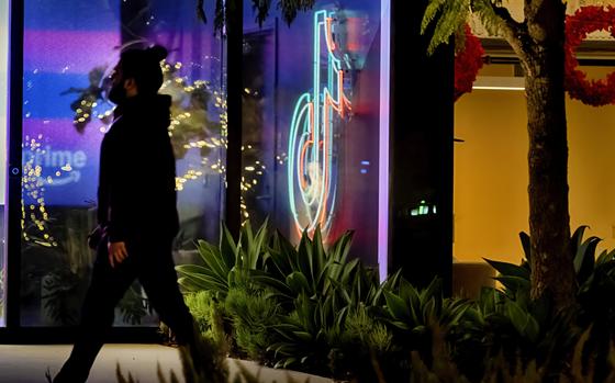 A neon TikTok logo hangs in the lobby of the TikTok office building in Culver City, Calif., on Tuesday, Dec. 3, 2024. (AP Photo/Richard Vogel)