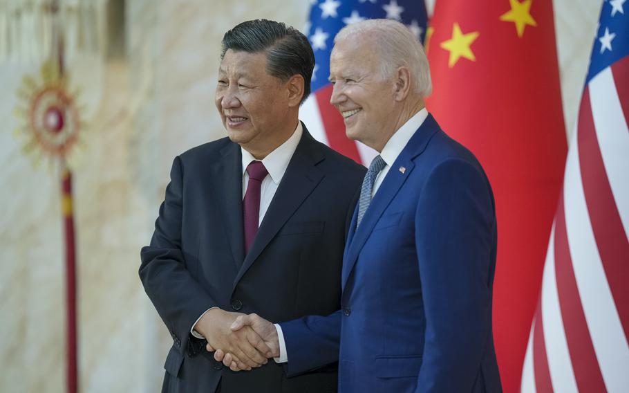 China’s Xi Jinping, left, shakes hands with President Biden, right.