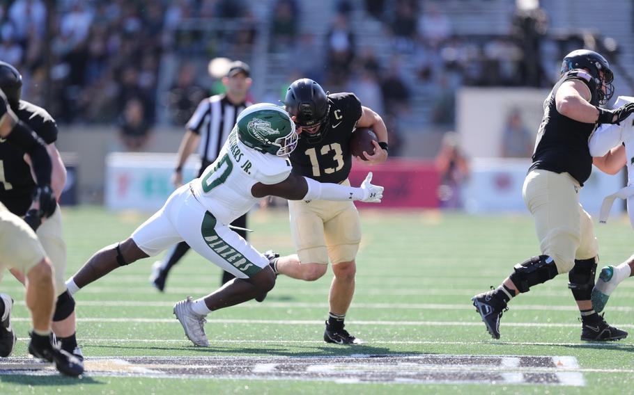 Army quarterback Bryson Dailey tries to evade a tackler against UAB.