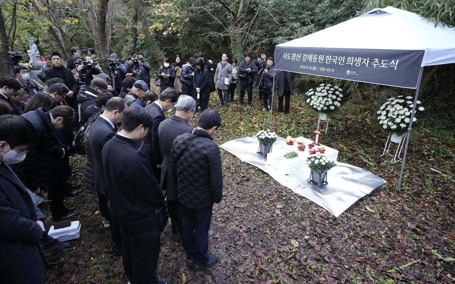 Relatives of Korean victims and South Korean officials offer a minute of silence during a memorial service in Sado, Niigata prefecture, Japan, Monday, Nov. 25, 2024, a day after boycotting a memorial organized by Japanese officials.