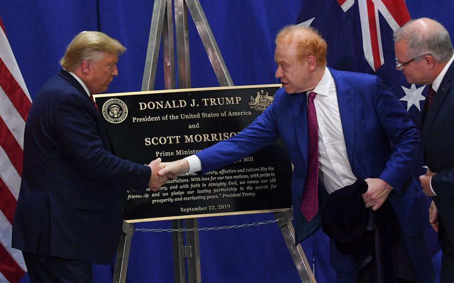 President Donald Trump, left, shakes hands with Global Chairman of Pratt/Visy Industries Anthony Pratt, second from right, as Australian Prime Minister Scott Morrison looks on during a visit to Pratt Industries plant opening in Wapakoneta, Ohio, on Sept. 22, 2019.