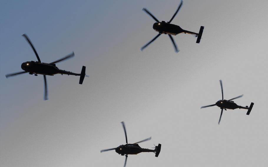 Four helicopters fly in the sky