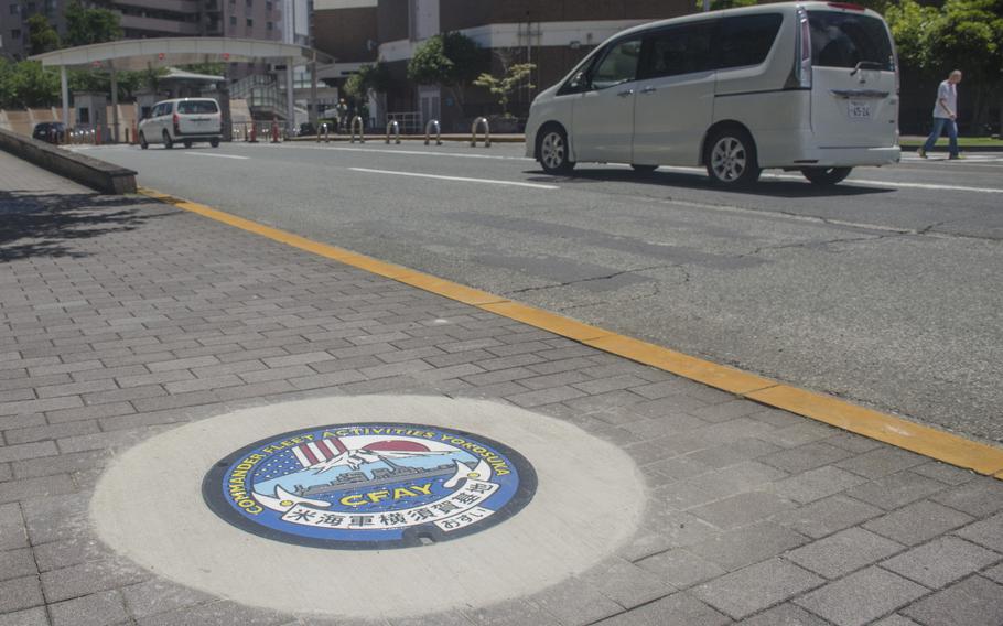 A brand new, colorful manhole cover, seen here June 24, 2034, was put in place near the main gate at Yokosuka Naval Base, Japan, on June 23, 2024.