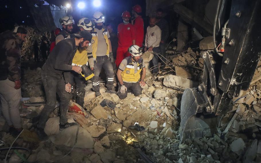 People search through debris after an explosion