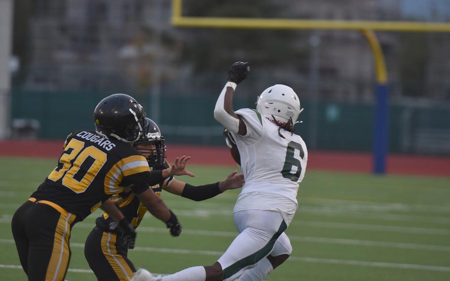 Naples’ Jeramiah Robinson twists sideways Friday, Sept. 20, 2024, to try to elude a pair of Vicenza defenders after making a catch in the Wildcats’ 28-6 victory.