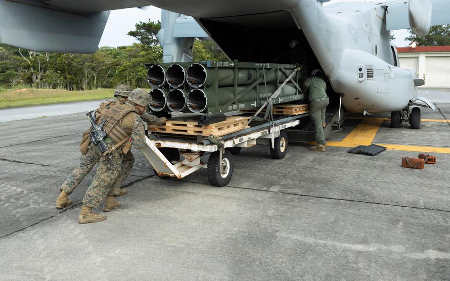 Marines load ammunition pods onto an MV-22B Osprey during an aerial High Mobility Artillery Rocket System resupply rehearsal on Camp Hansen, Japan, on May 8, 2024. 