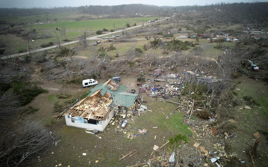 An emergency vehicle among smashed buildings and debris.