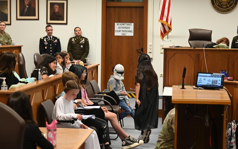 Darth Vader, portrayed by Grafenwoehr Elementary School fourth grader Gabby Theadore, takes the witness stand during the mock trial of Luke Skywalker on May 20, 2024, in the 8th Judicial Circuit courtroom at Rose Barracks in Vilseck, Germany.