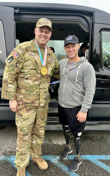 Paralympic champion and Navy SEAL veteran Dan Cnossen poses for a photo with a service member during a USO-organized trip to Alaska.