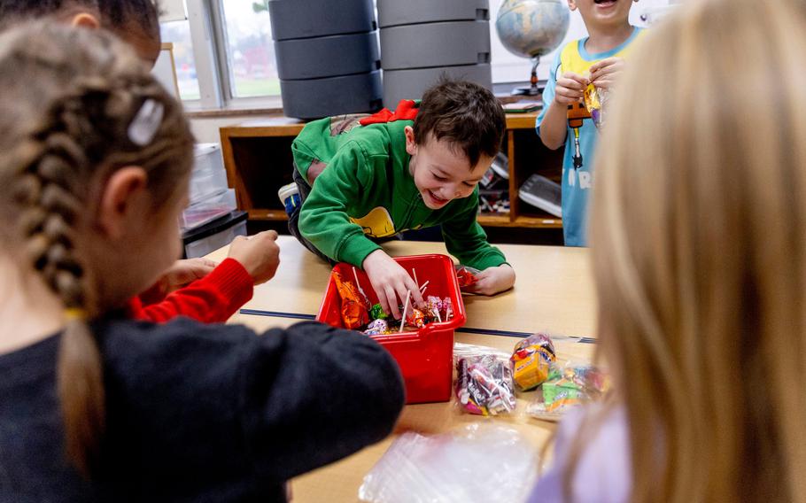 First and second grade students help fill bags of donated Halloween candy