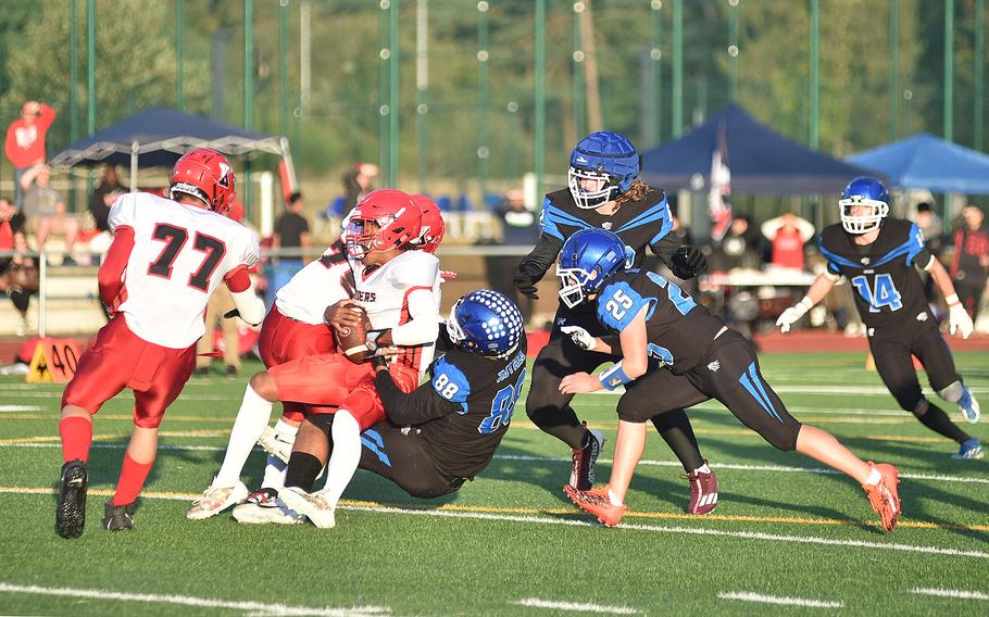 Ramstein defender Javier Harrington brings down Kaiserslautern quarterback Rueben Todman during a Sept. 13, 2024, game at Ramstein High School on Ramstein Air Base, Germany.