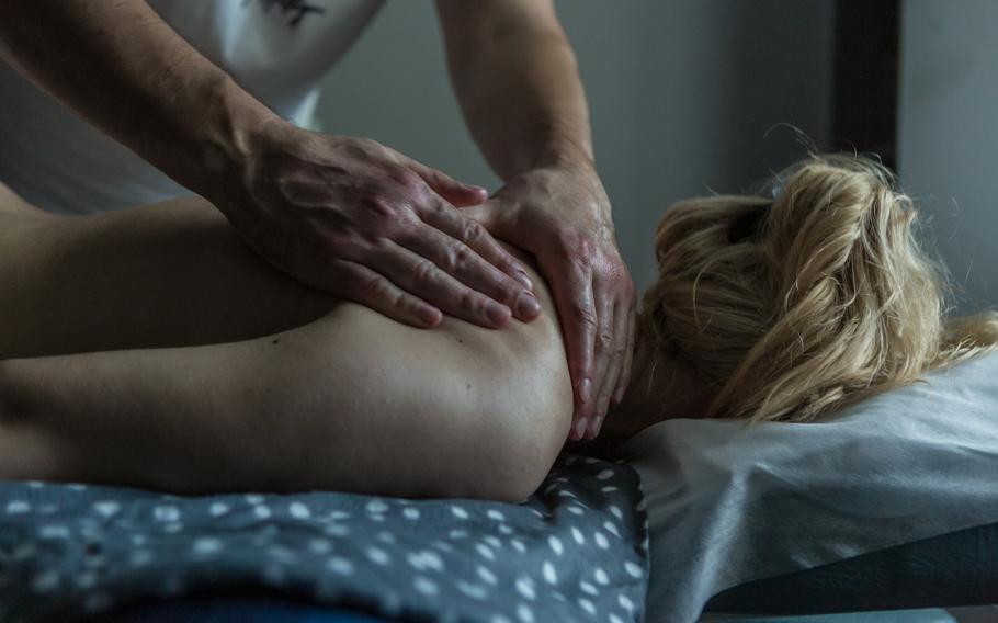 Abdulin gives a massage to Elina Fediuk. His work has given him an important sense of purpose after a difficult recovery.