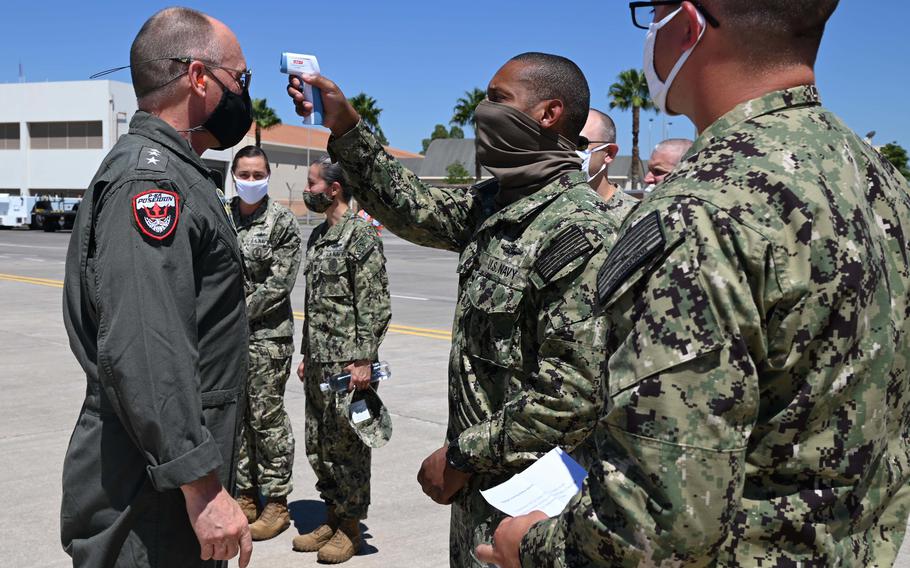 Vice Adm. Gene Black, commander of U.S. 6th Fleet, has his temperature checked upon arrival at Naval Air Station Sigonella on July 27, 2020, as part of COVID-19 safety measures.