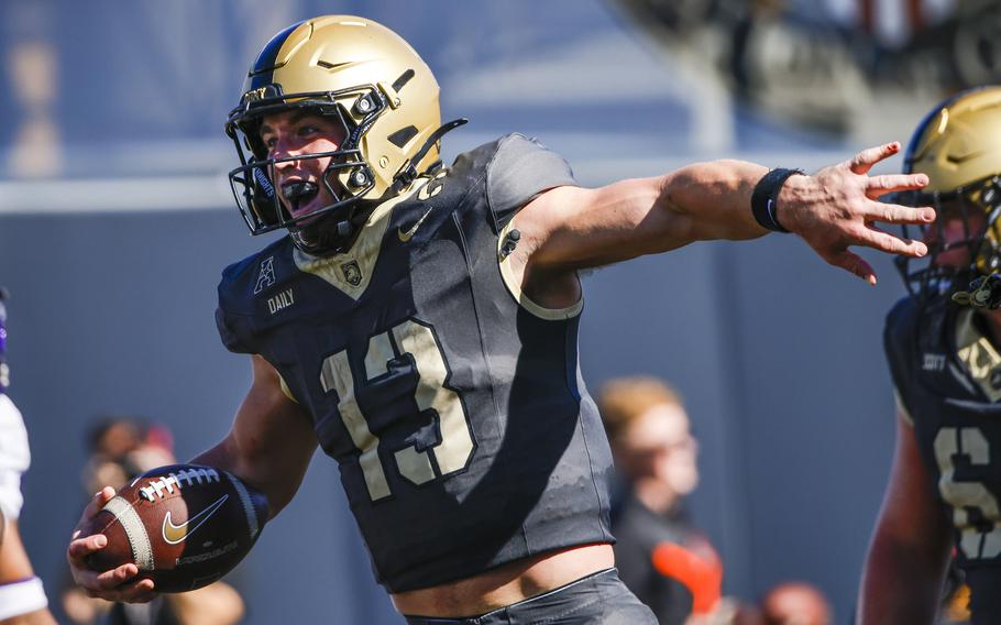 Army quarterback Bryson Daily celebrates a touchdown 